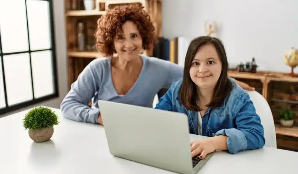 a mother with her special needs child on her laptop